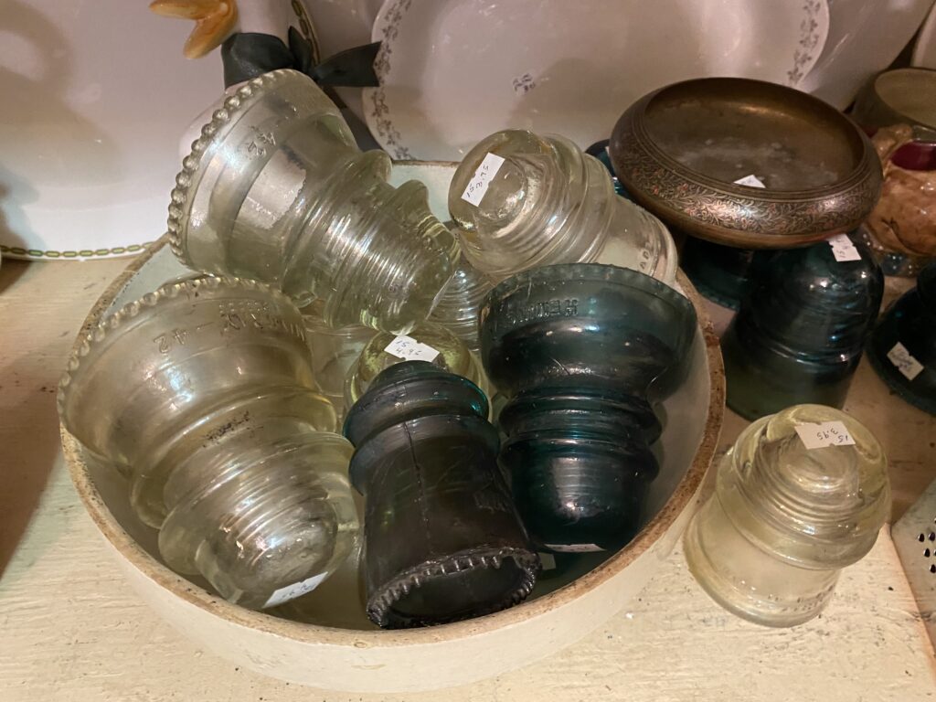 Vintage glass insulators in clear and blue